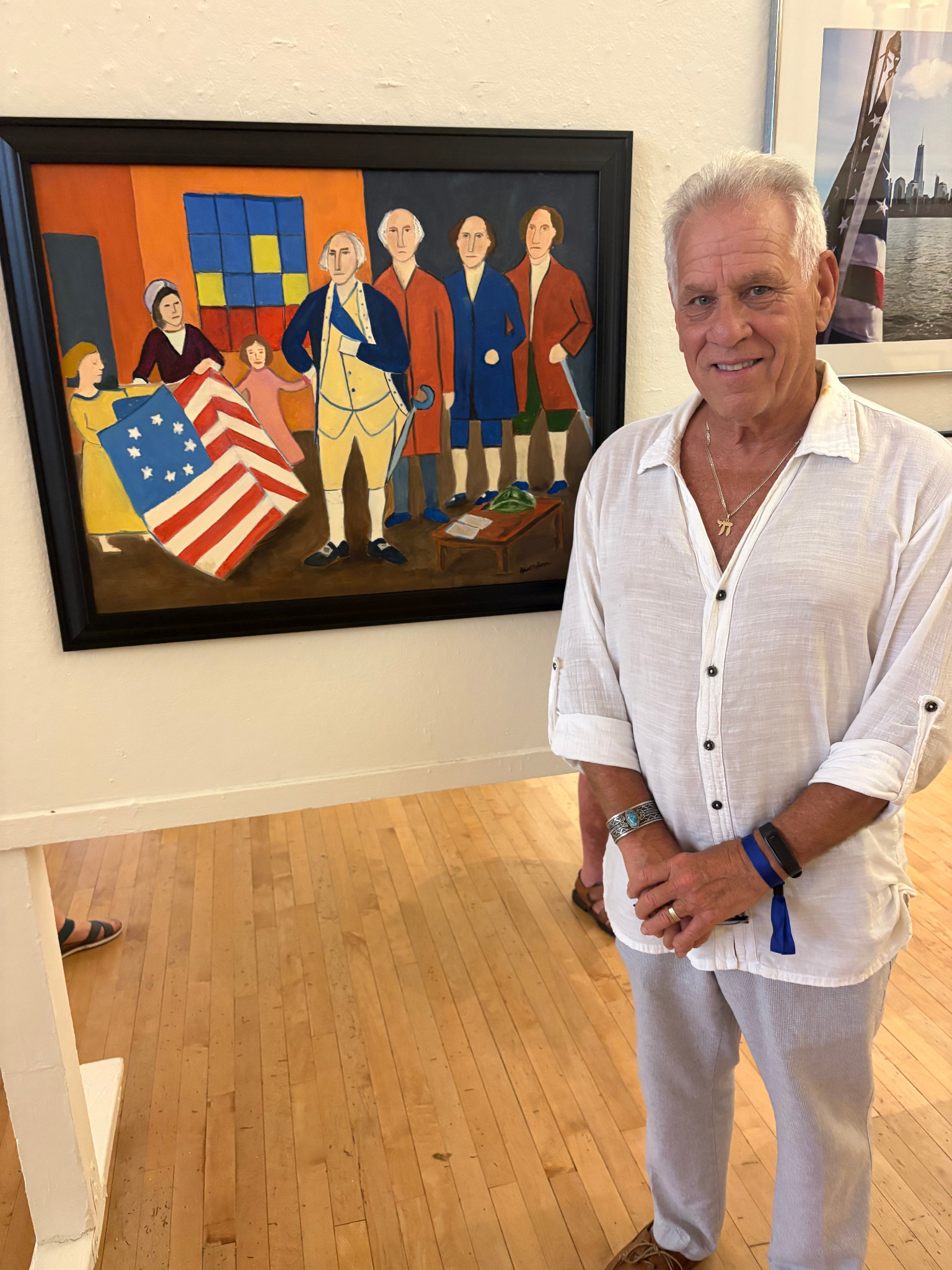 Robert G. Fishman standing beside his painting The Presentation